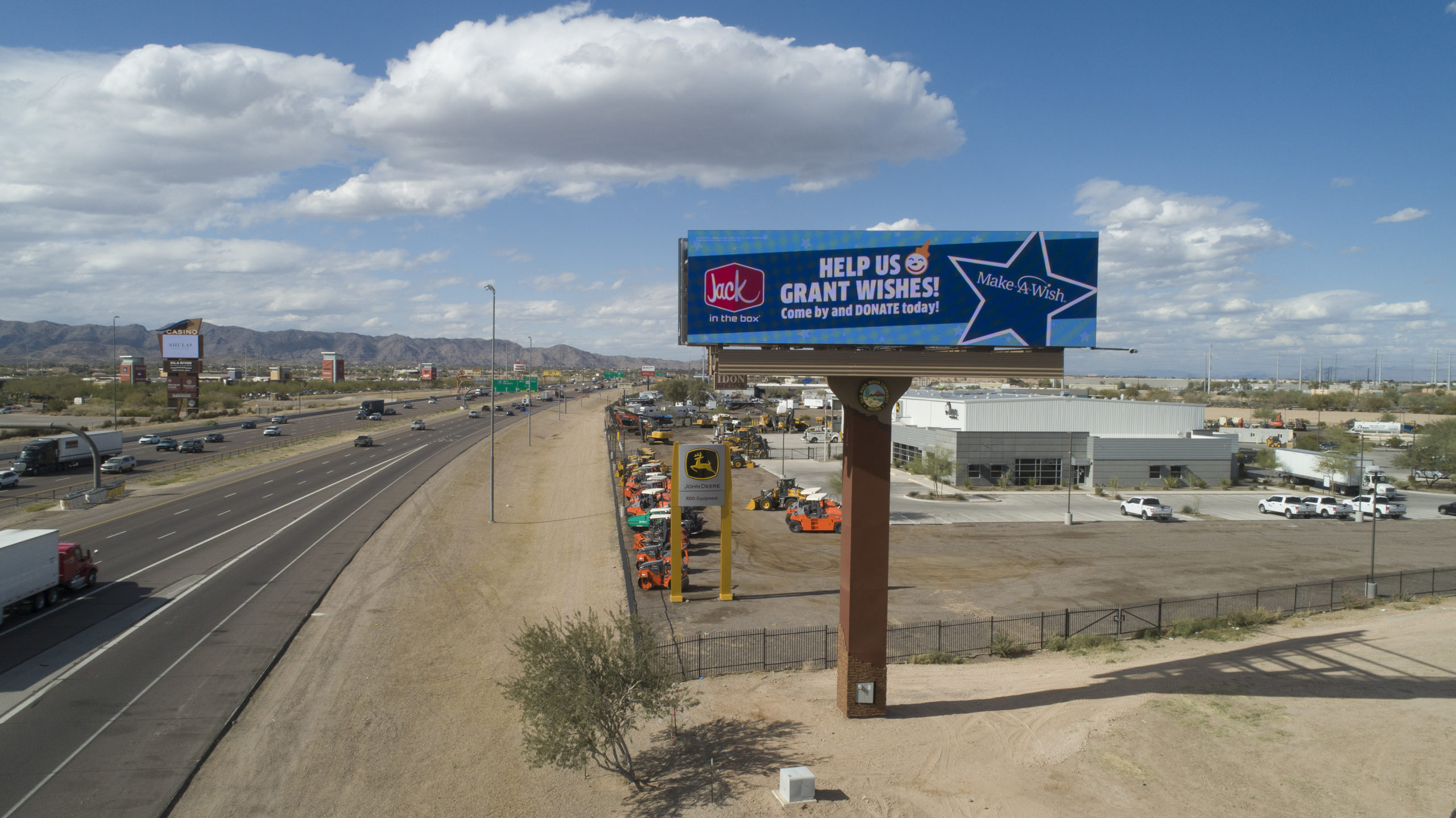 Billboard with Jack in the Box outdoor advertisement next to road